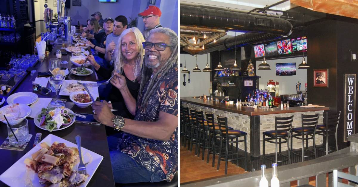 people enjoying dinner at long table at restaurant on the left, bar area on right