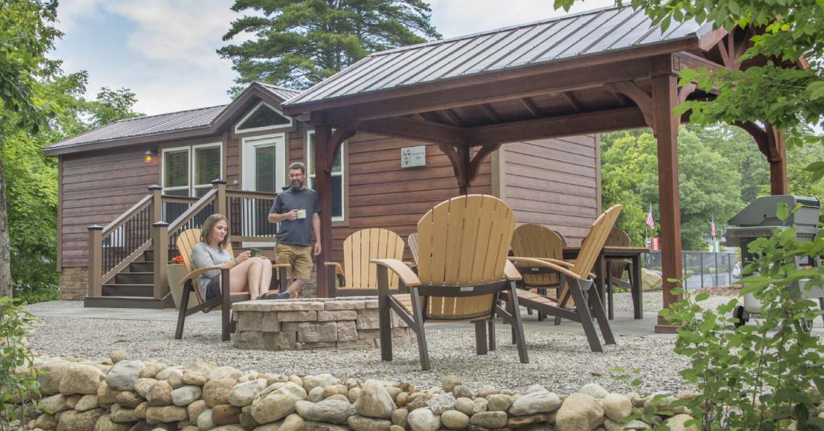 couple at outside firepit by cabin