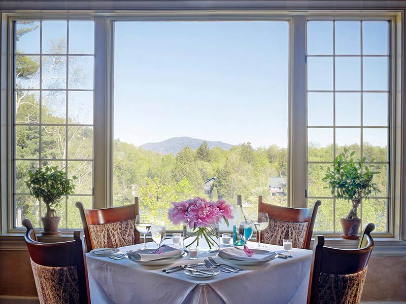 Picturesque view of the Adirondacks from a table in front of a window at The View at Mirror Lake