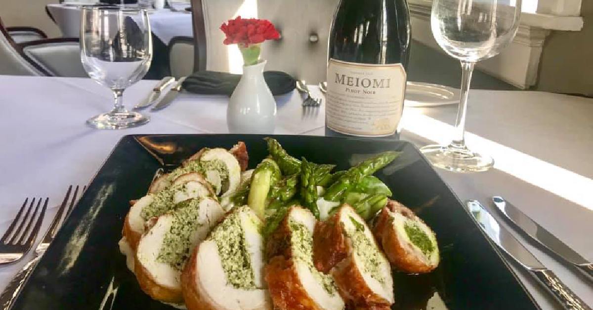 Chicken roulade with bottle of wine and glasses