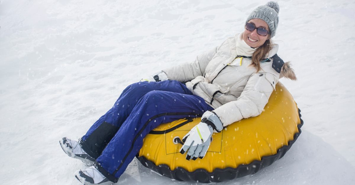 a woman in a yellow snow tube