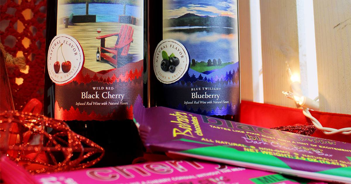 bottles of black cherry wine and blueberry wine with chocolate bars