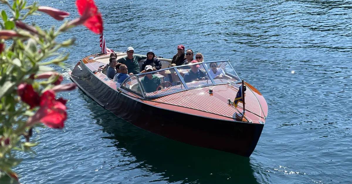 people in boat on lake george