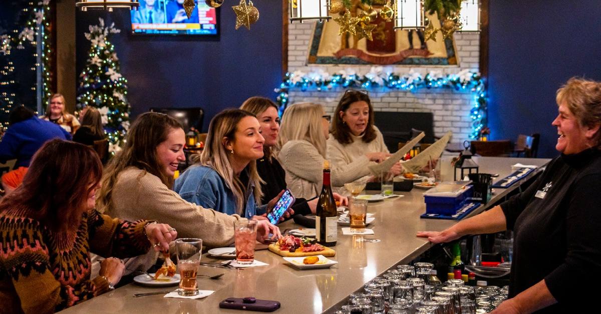 women at bar decorated for christmas