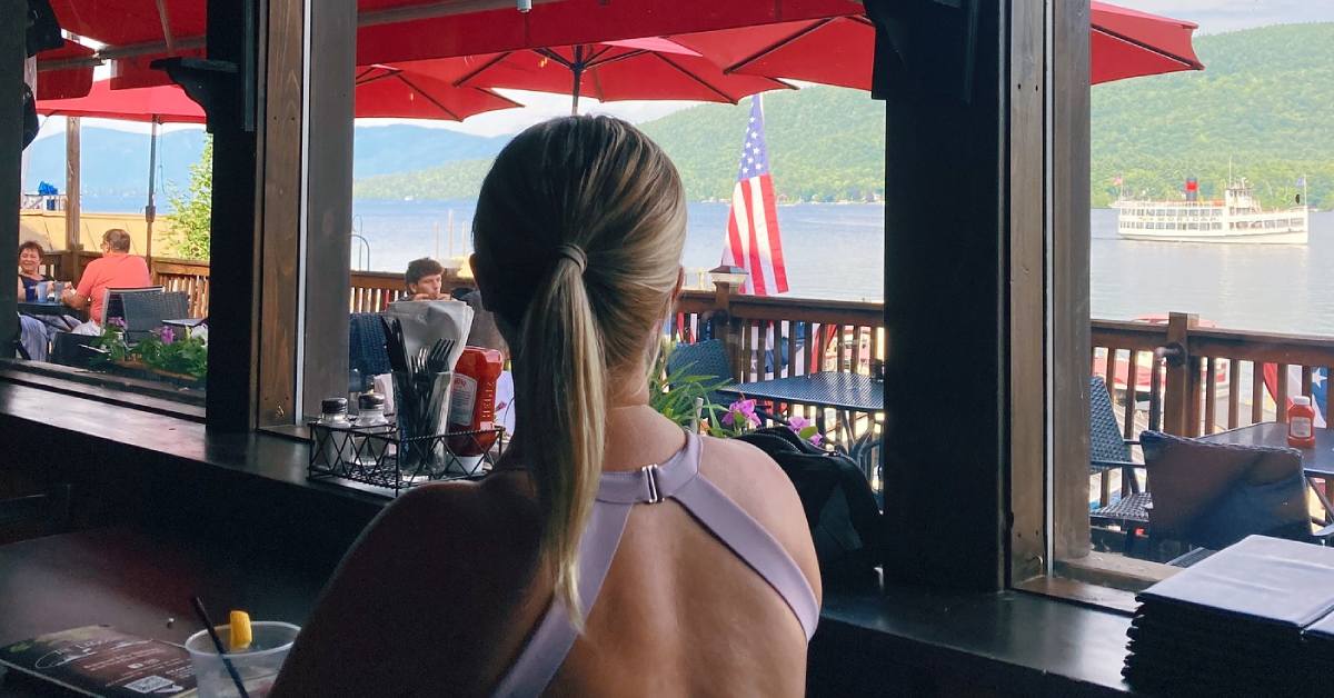 woman looks out at view of lake george from lagoon restaurant