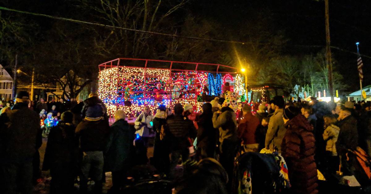 people watching a holiday lighted tractor parade