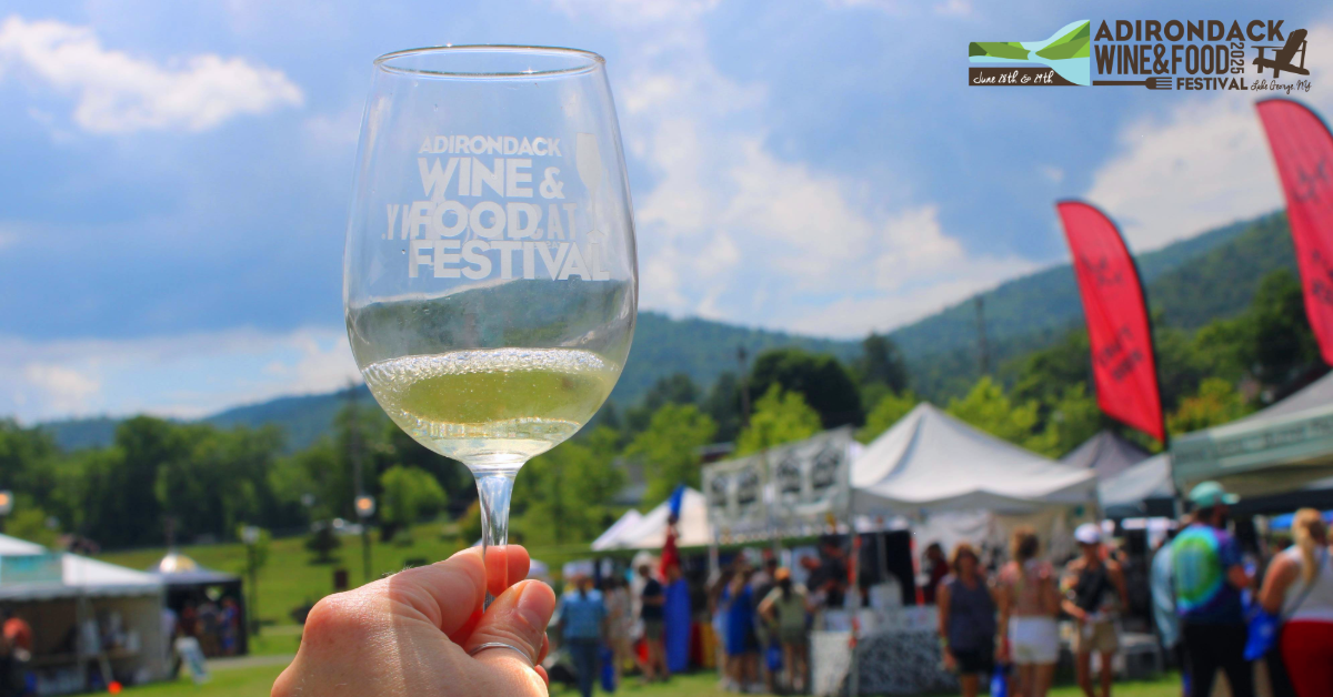 white wine glass held up against festival