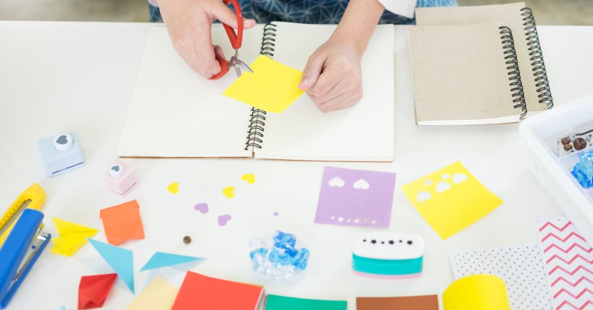 person working on a scrapbook