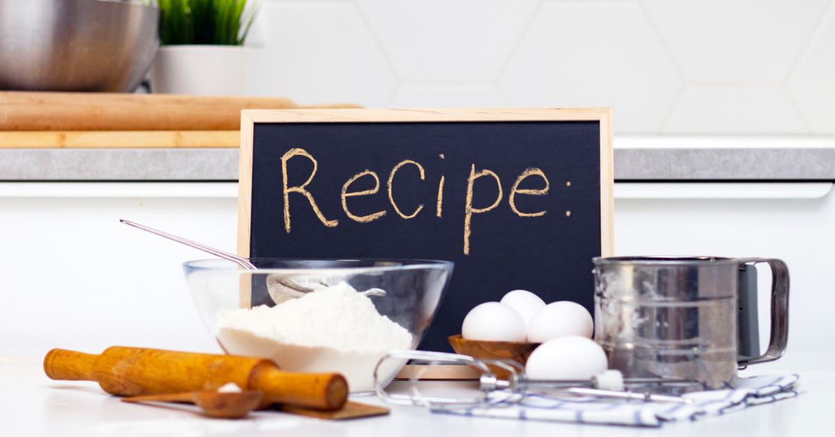 recipe sign by eggs and kitchen equipment