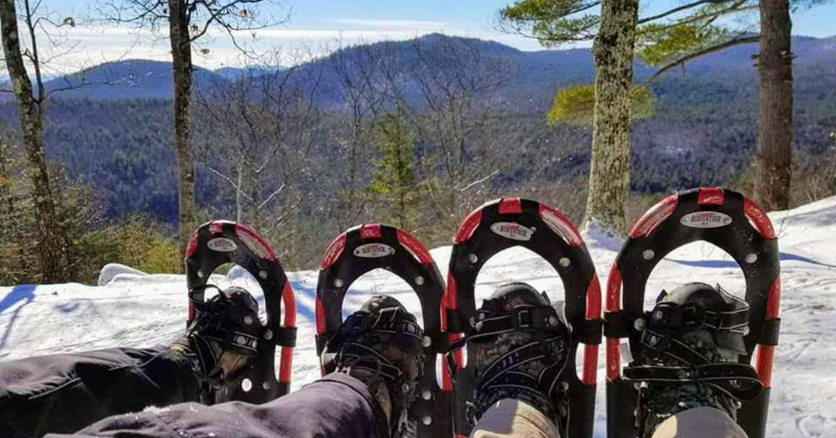 two pairs of snowshoes pose on mountain in winter