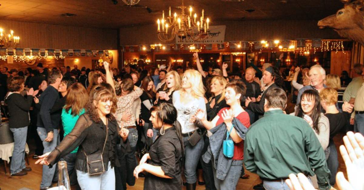 people dancing around inside a small ballroom