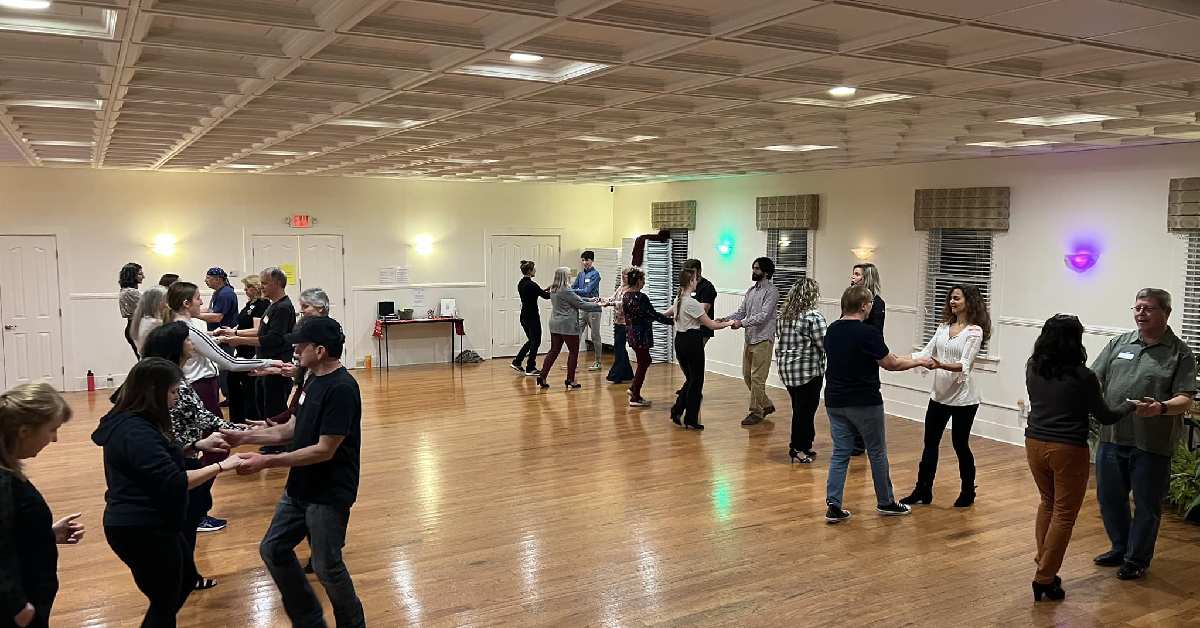 people dancing in a large dance room