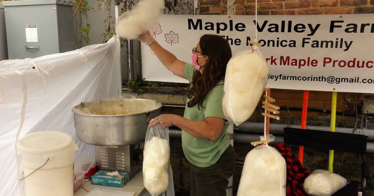 woman at vending booth with maple cotton candy