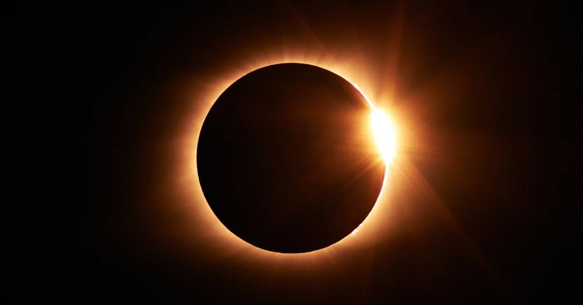 solar eclipse with small glimmer of sunlight