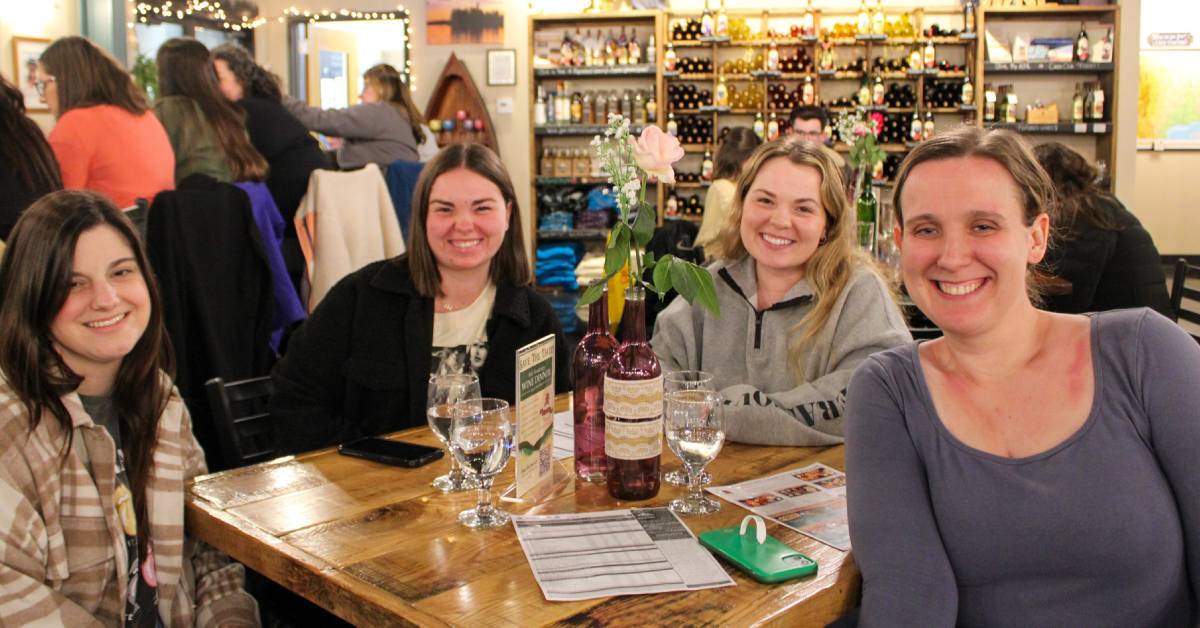 four women play trivia at adirondack winery