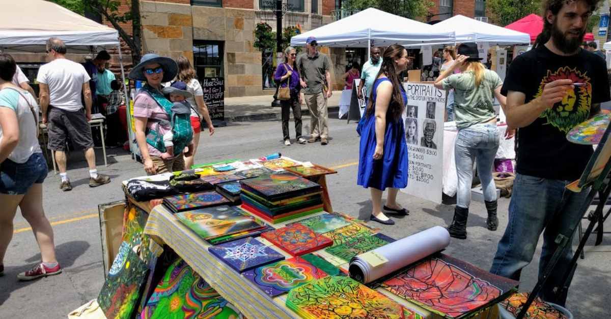 vendor tables with artworks on display in a street fair