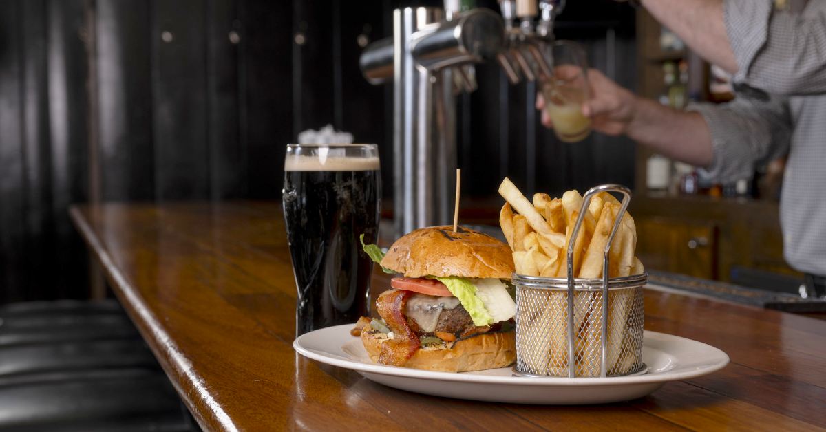 beer, burger, and fries on a bar