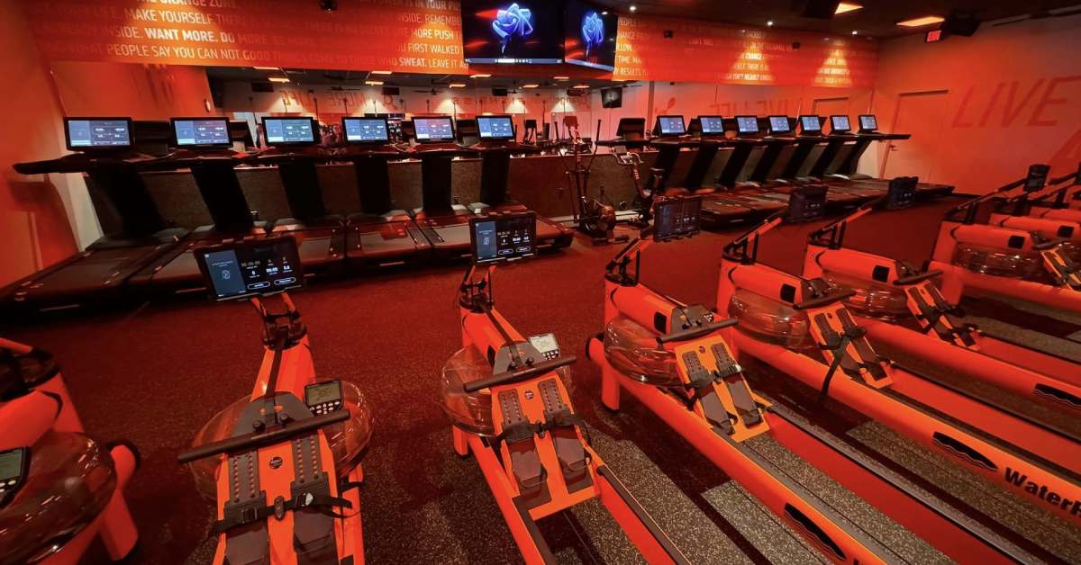 fitness equipment in a room with orange lighting