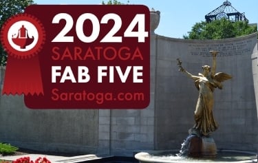 fab five badge in front of a fountain in Saratoga