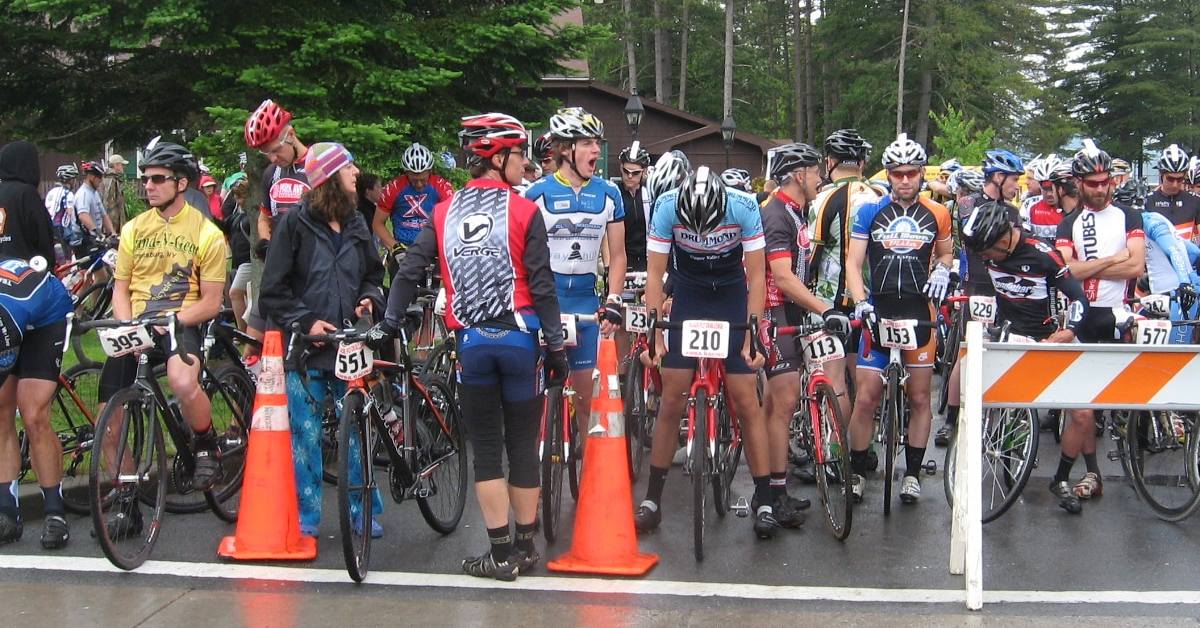 bicyclists lined up at a start line for a road race
