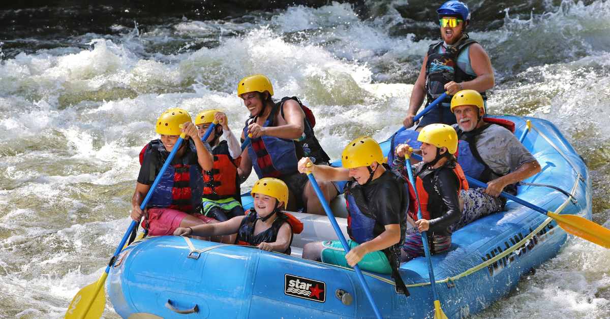 people in a blue raft on a raging river