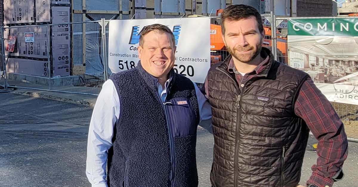 two men standing by construction site