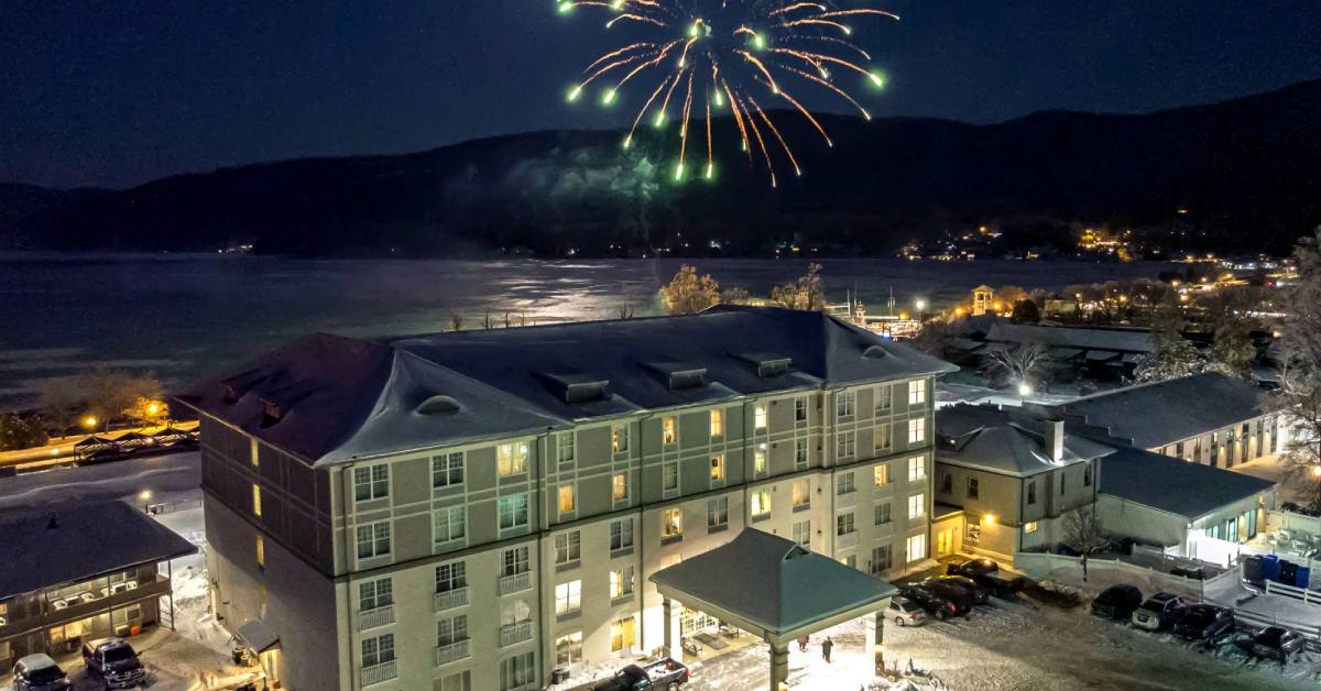fort william henry in winter with fireworks over the lake