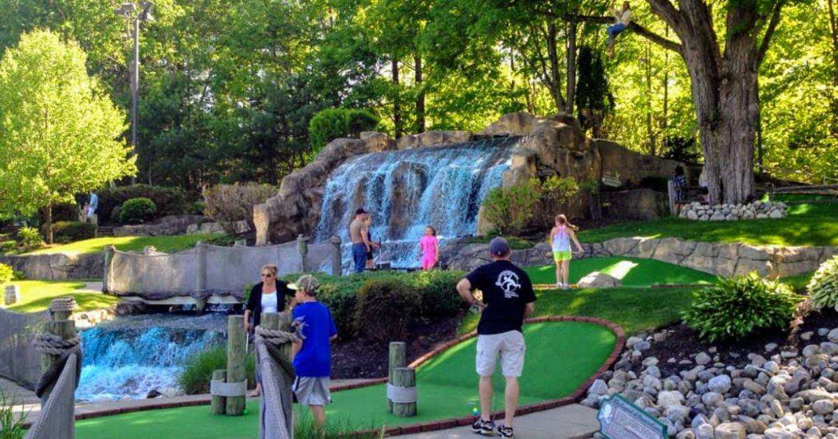 people mini golfing at pirate's cove
