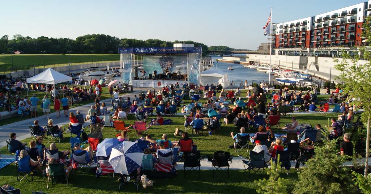 people watching a concert at the harbor