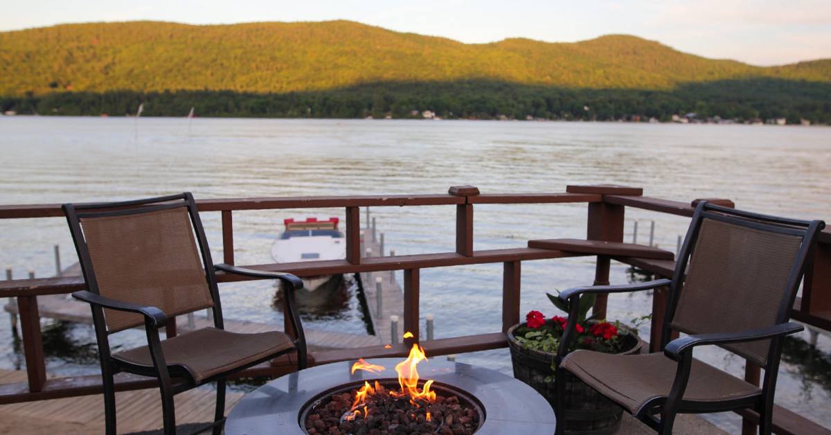 view of lake with fire pit at park lane on lake george