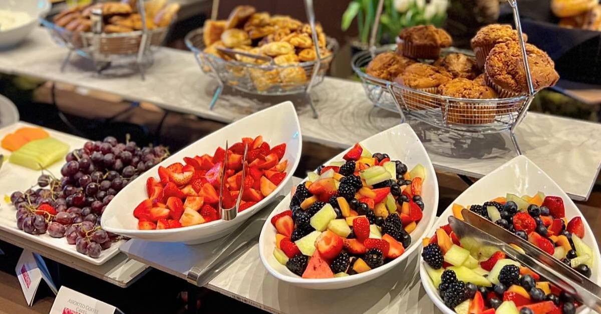 buffet table with fruit and muffins