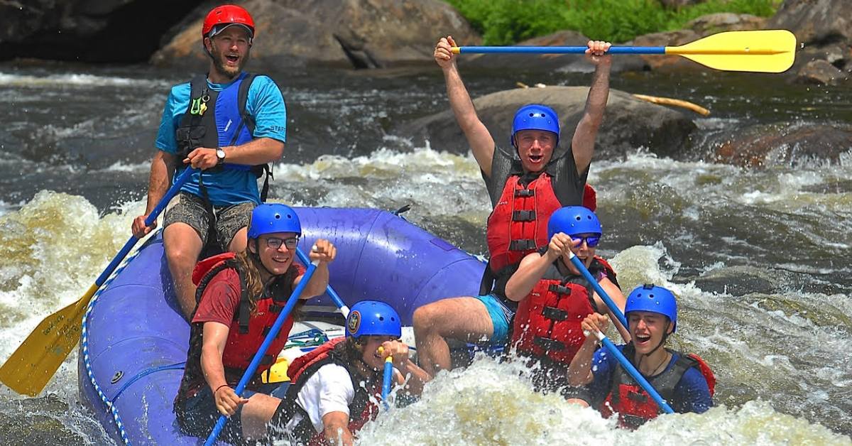 whitewater rafters in the adirondacks on a purple raft