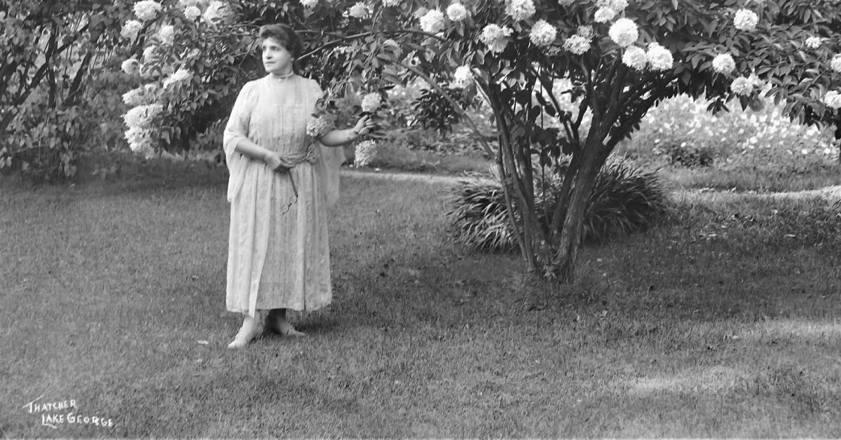 mracella sembrich stands by a flowering tree