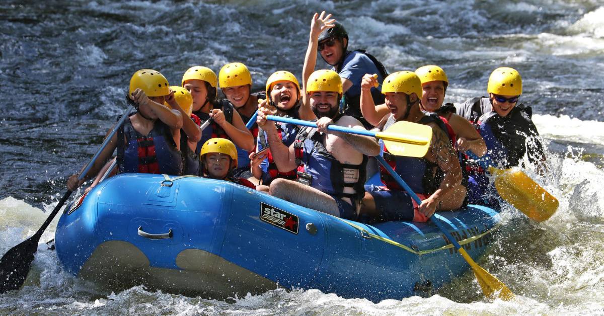 whitewater rafters in the adirondacks in blue raft