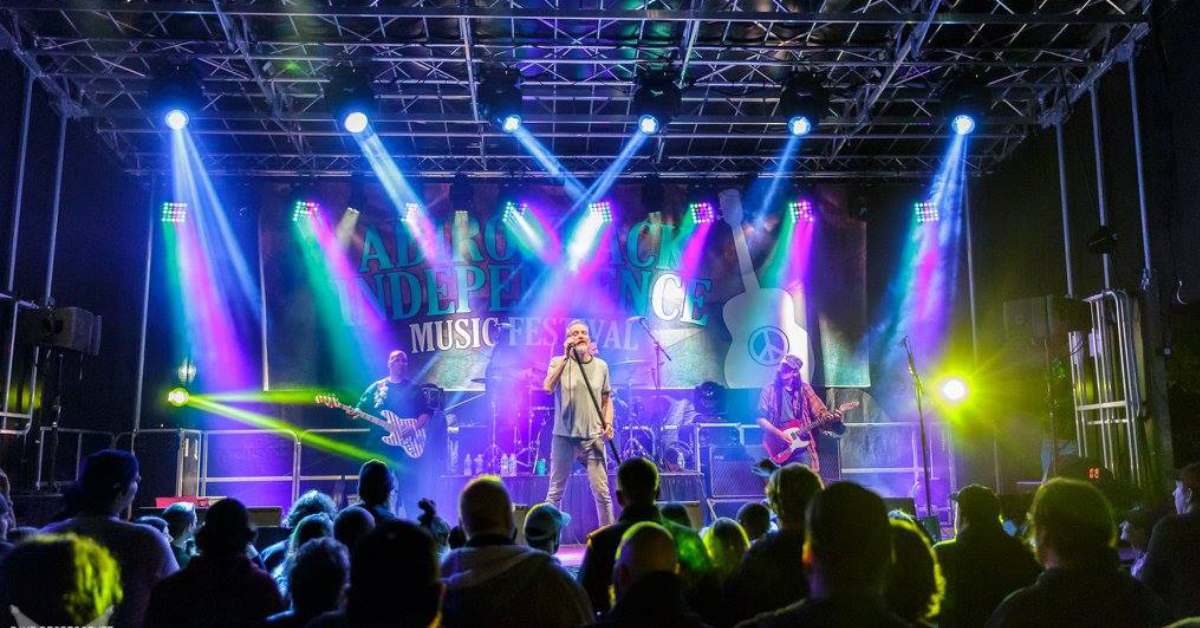 Singer on stage under colorful lights