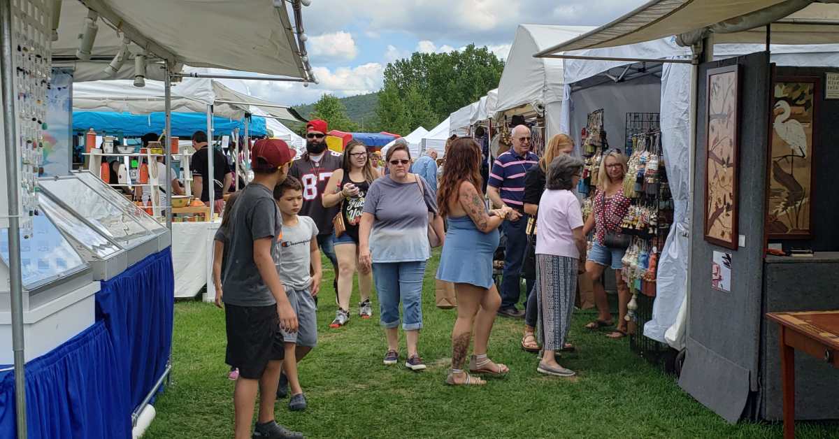 People walking next to vendor booths