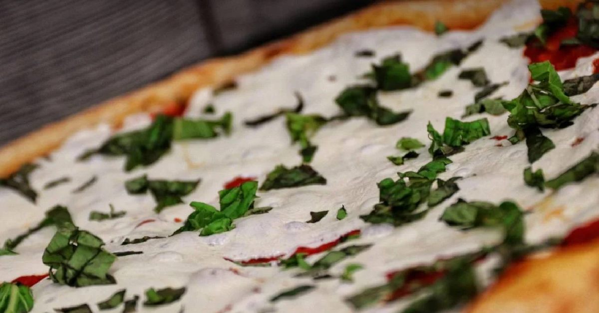 pizza with heavy white cheese and basil