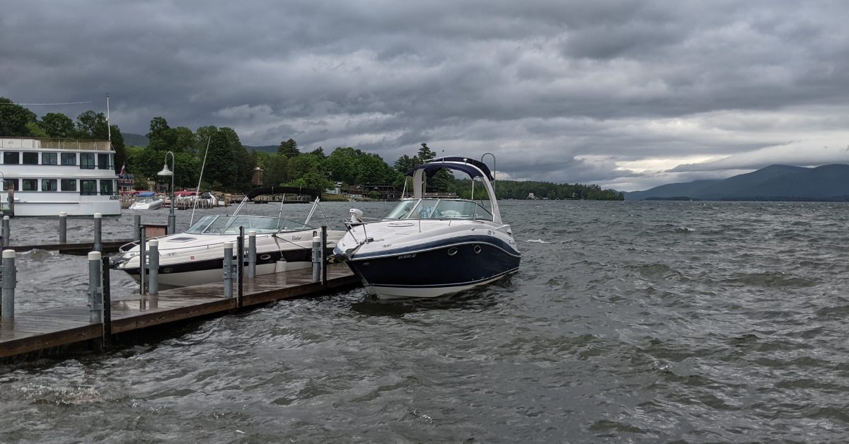 boat docked in lake george, storm clouds above