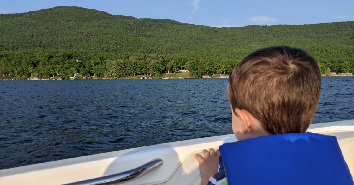 kid looks out over boat edge