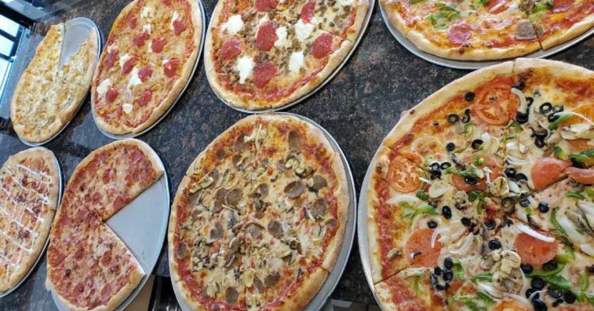 eight pizzas on a table