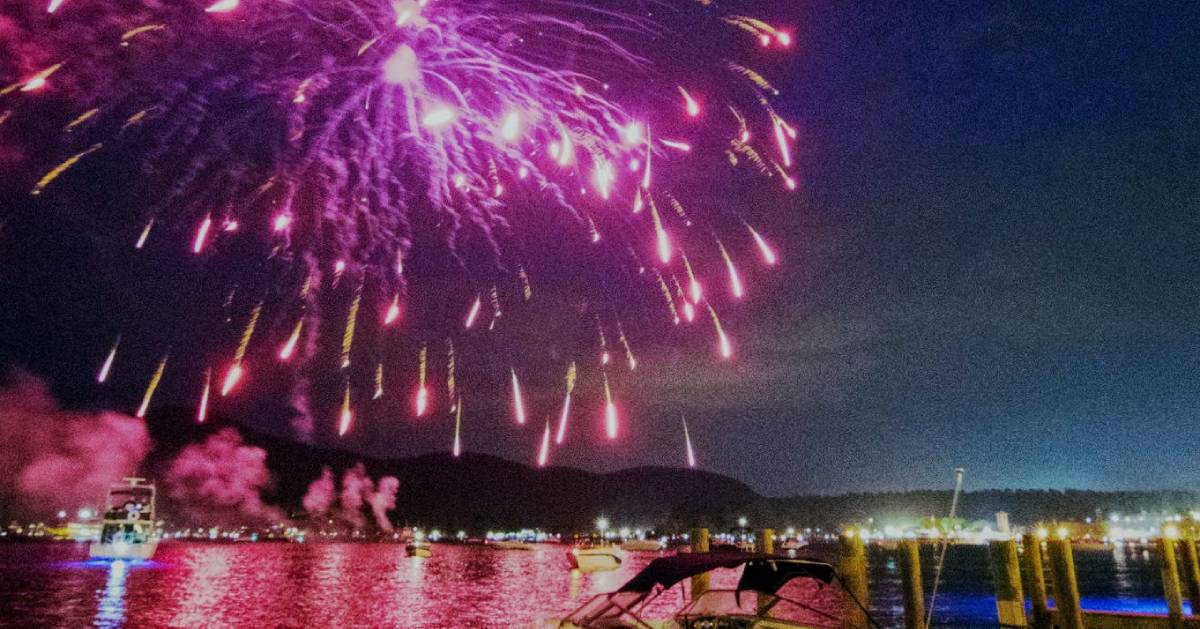 purple fireworks over a lake