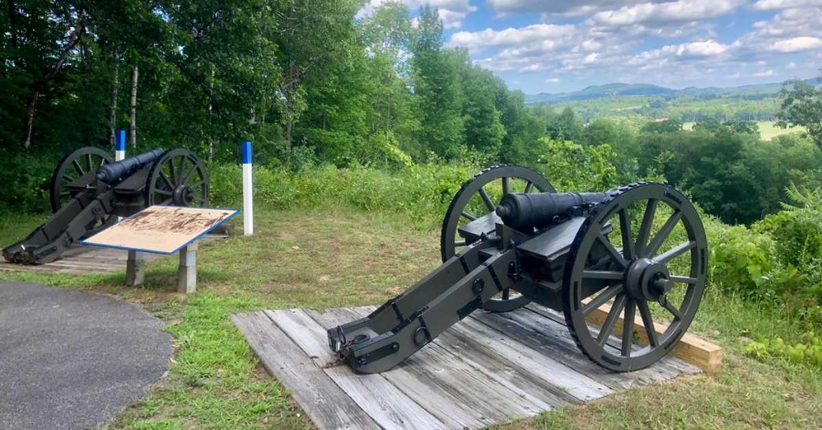 two cannons facing a historical park view