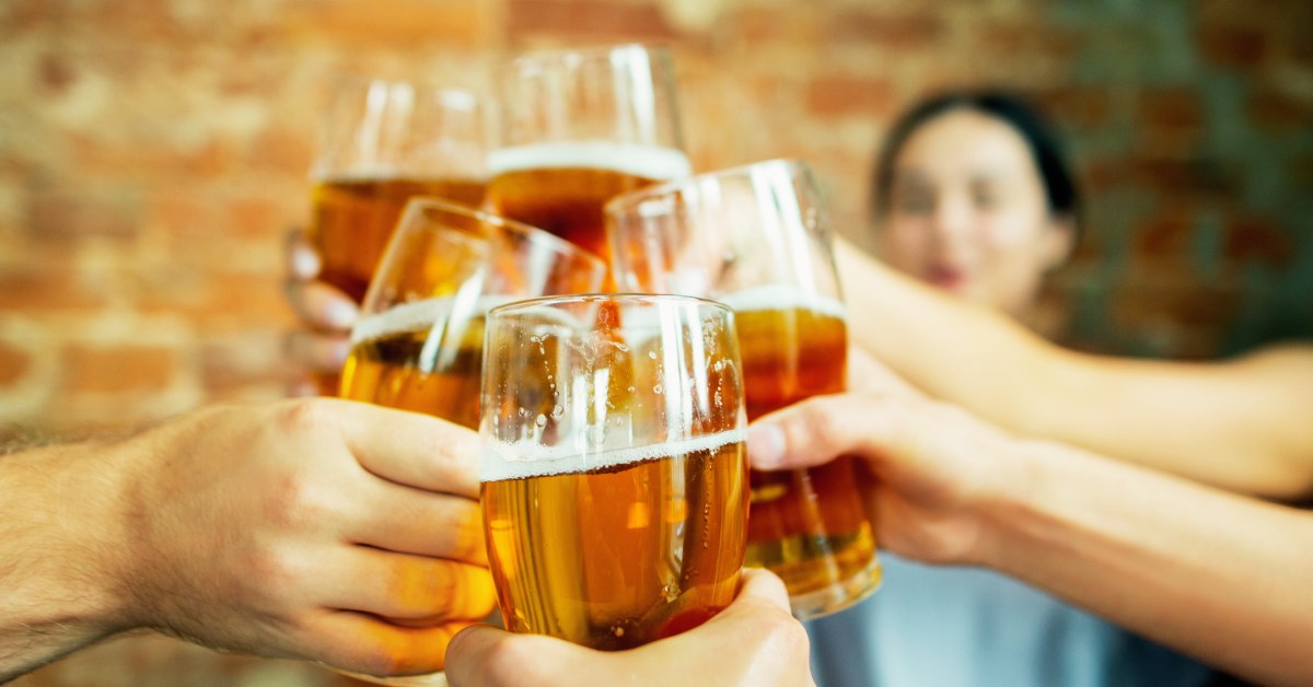 a group of people cheers-ing beer