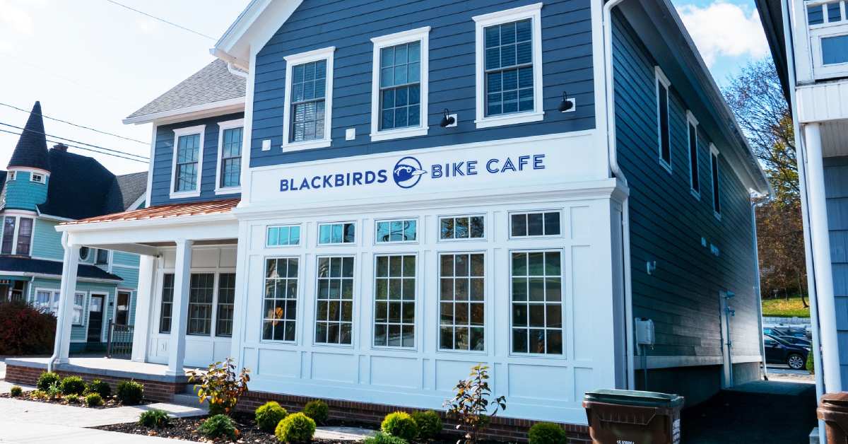 outside of blackbirds bike cafe facing windows and logo 