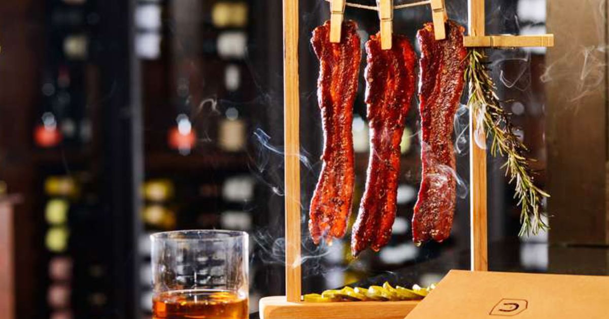 aesthetic of morrisseys with bacon hanging down from clothespins and alcoholic drink 