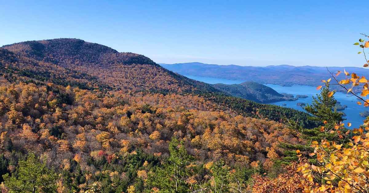 mountain photo with fall foliage and water 