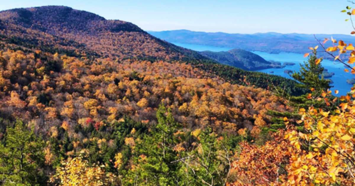 mountain photo with fall foliage and water 