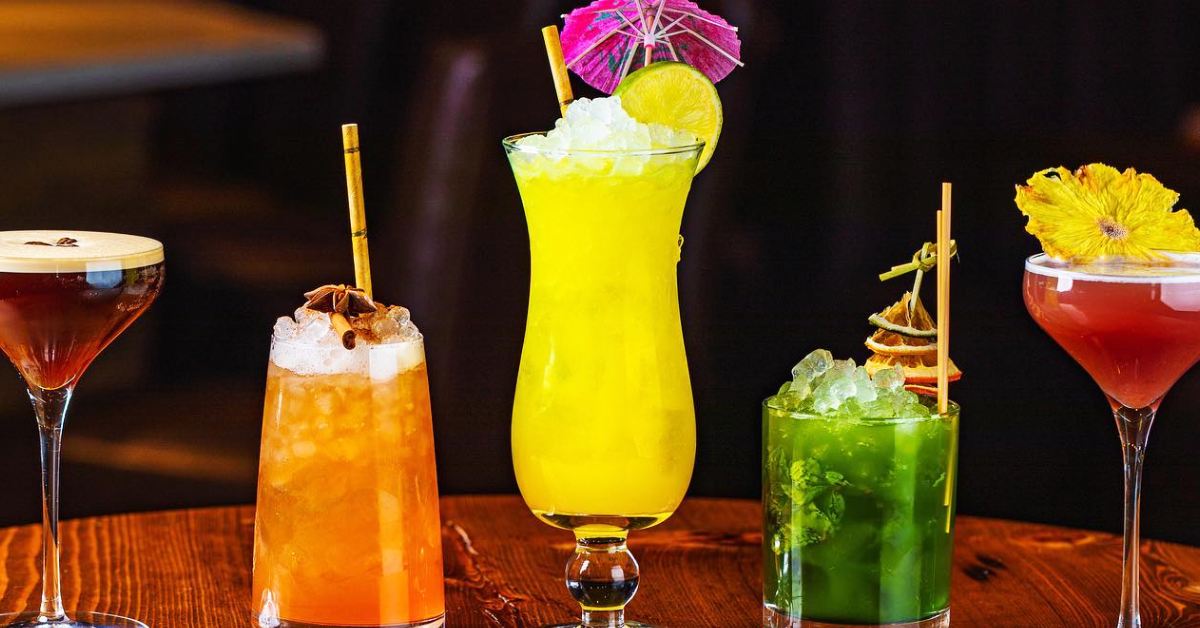 5 cocktail drinks lined up in a row