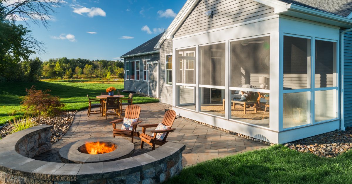 house with fire pit in backyard and screened in porch