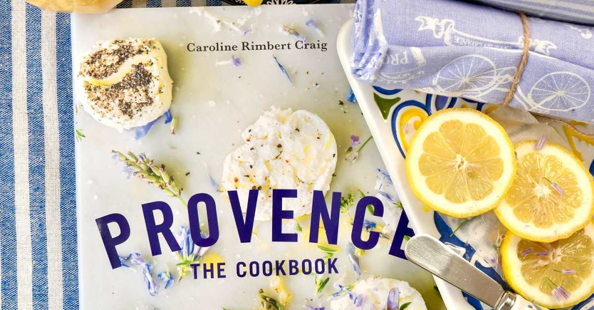 Close up of cookbook on blue and white striped table cloth with lemons next to it